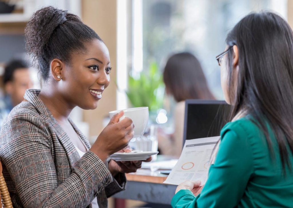 #2. United States Two women discussing business over coffee.
