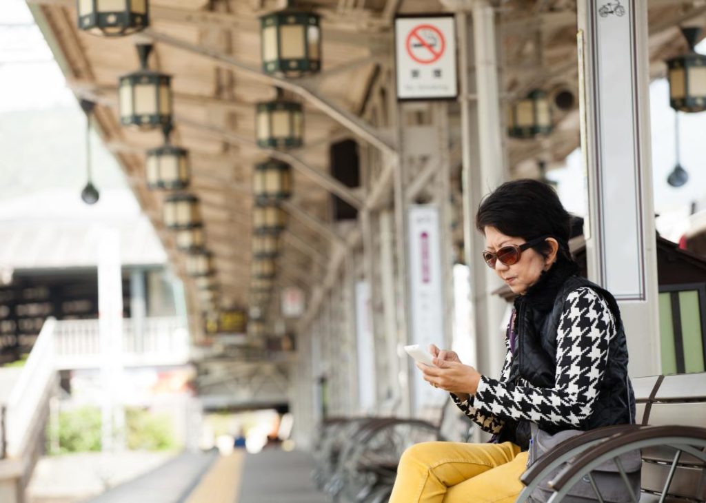 #14. Japan A woman waiting for a train in Japan.