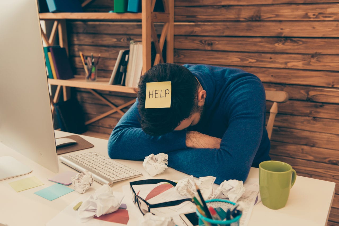 Portrait of tired, overworked man having long working day and needing help