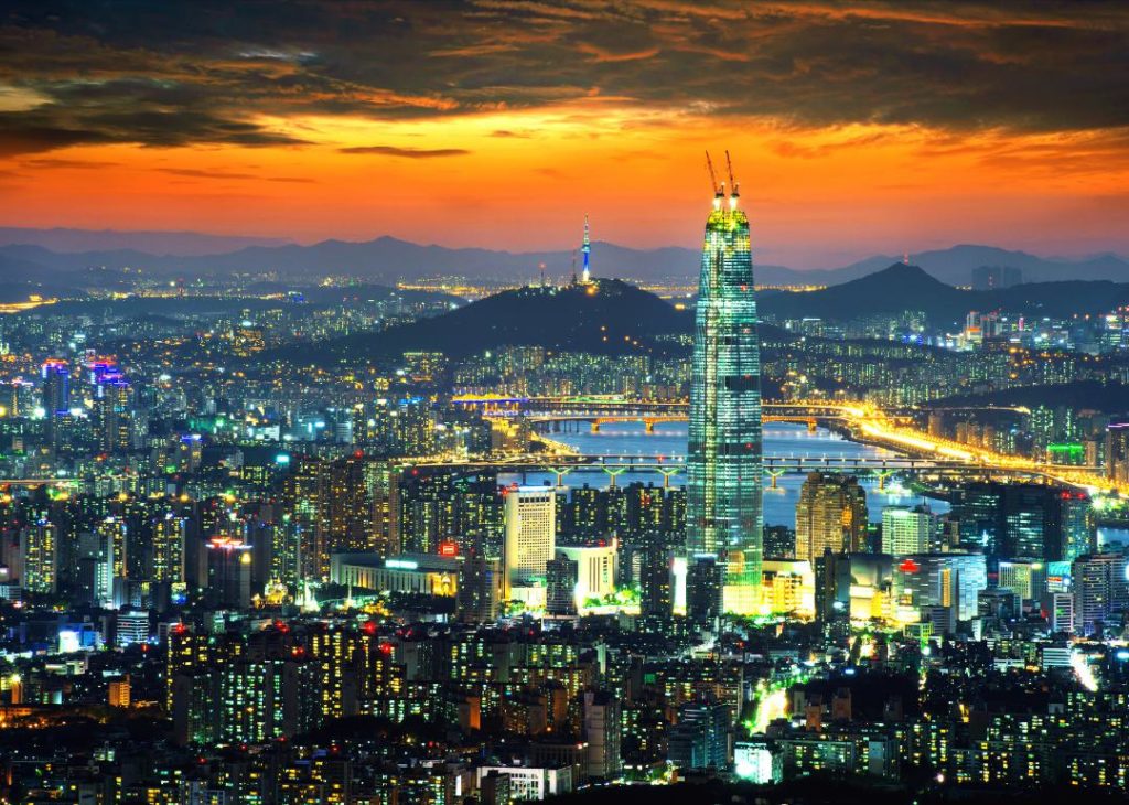 Seoul, South Korea skyline in the evening with an orange sky.