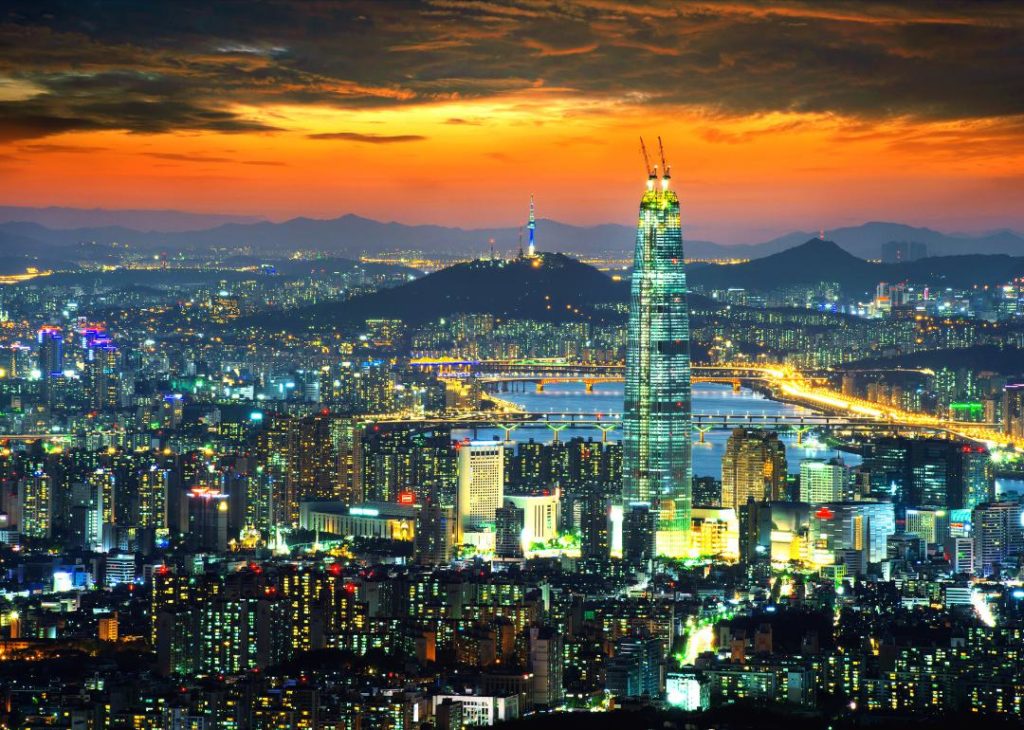 #11. South Korea Seoul, South Korea skyline in the evening with an orange sky.
