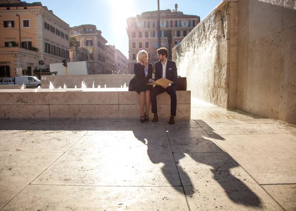 #8. Italy Two business people sitting by a fountain in Rome.