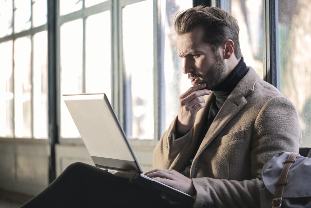 Confused man at laptop