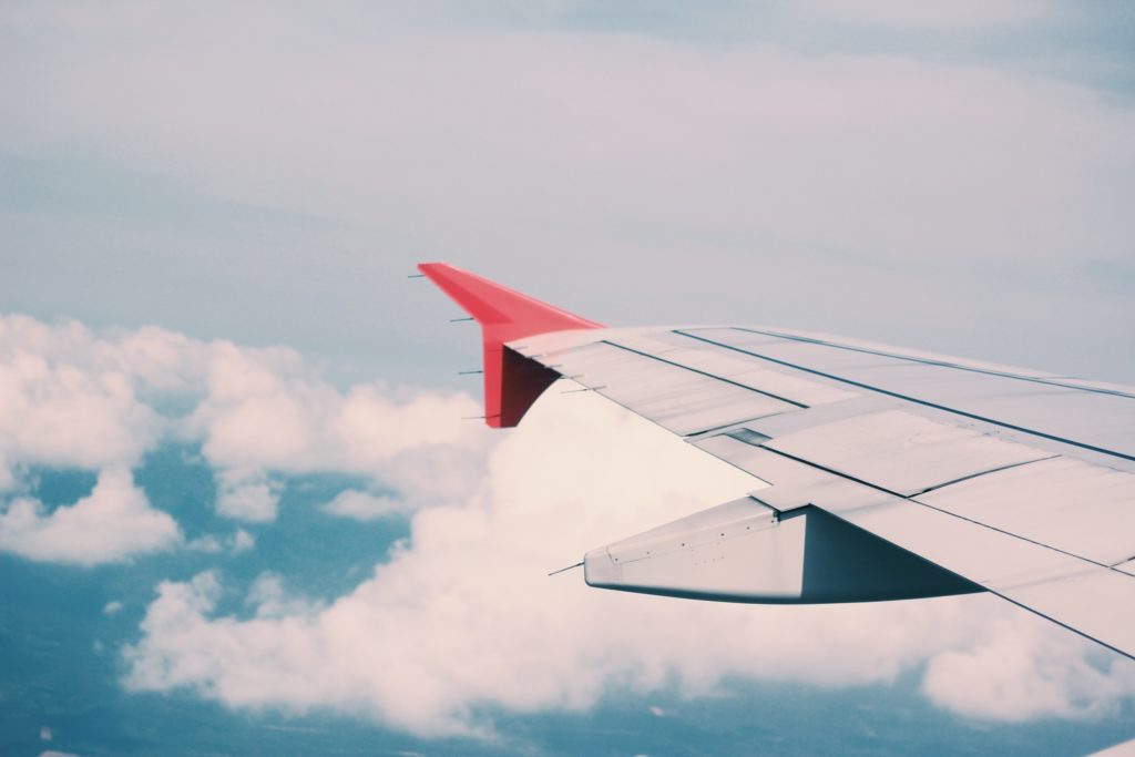Wing of a plane over clouds