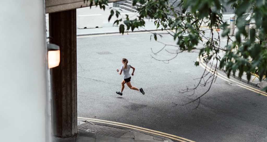 Woman running through city