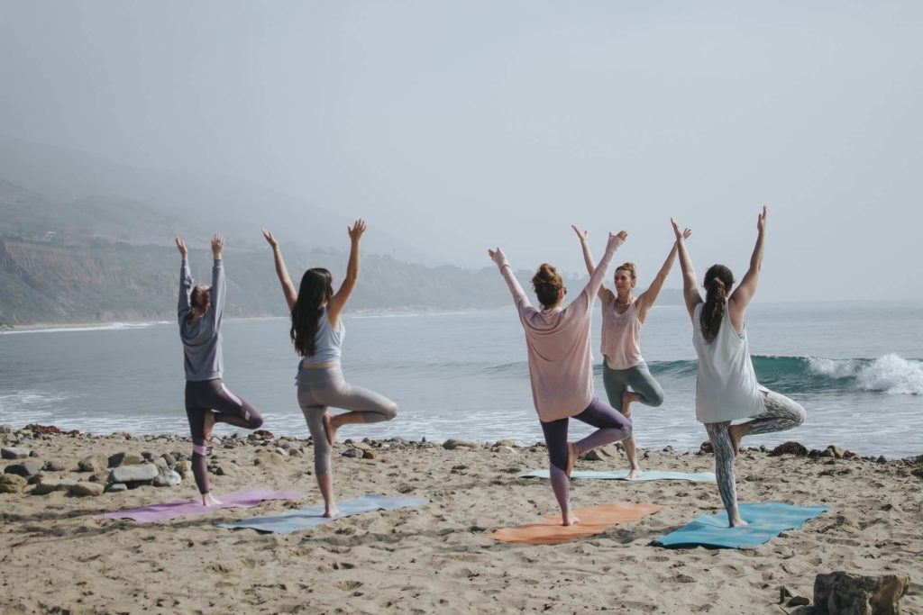 group yoga on beach