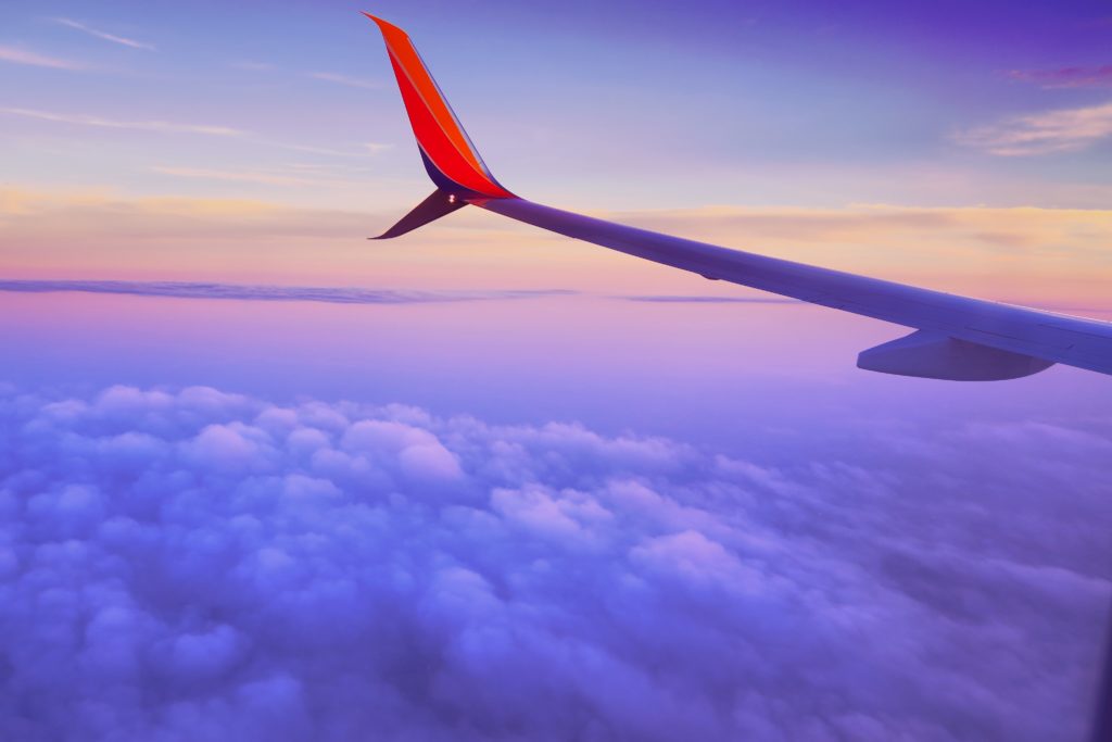 Plane wing over clouds
