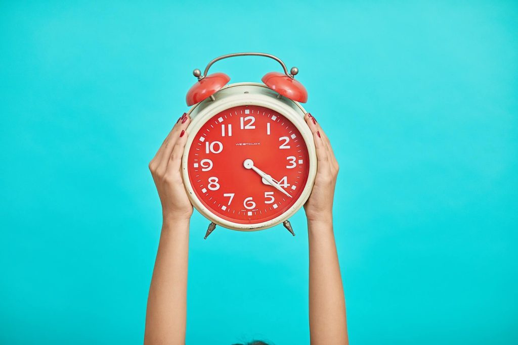 woman holding clock
