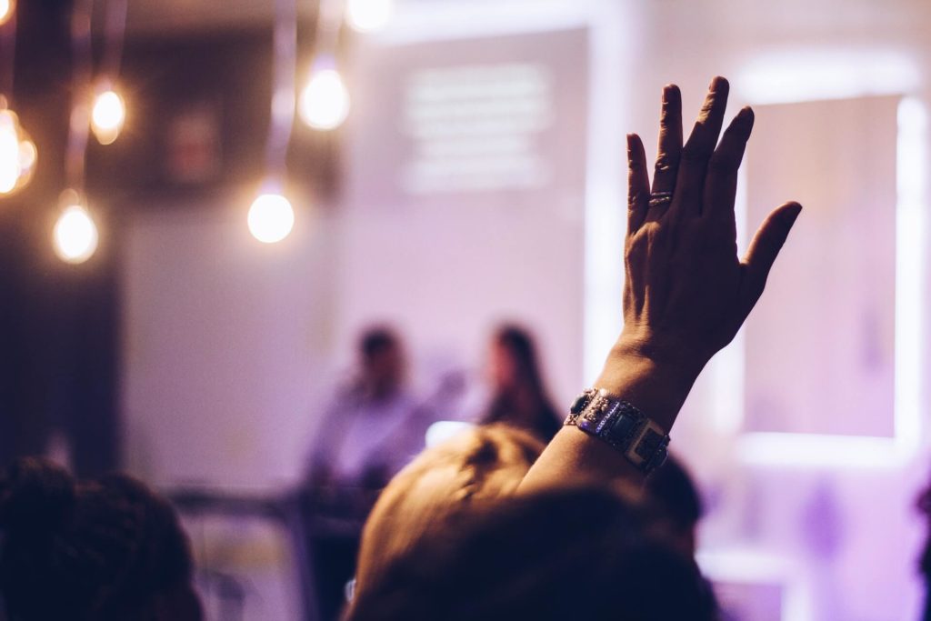 woman raising hand