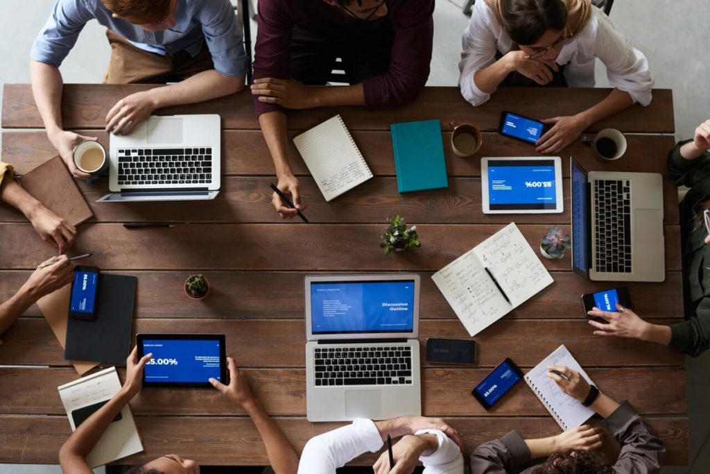 laptops on table coworkers