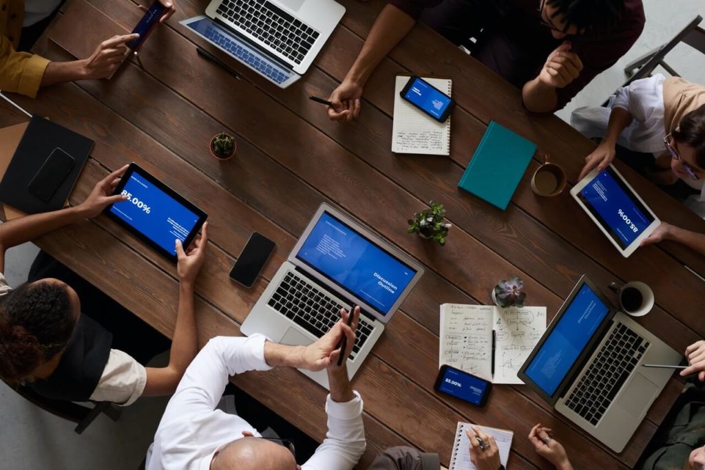 people on table with laptops