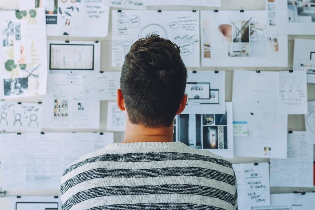 guy in front of brainstorm board