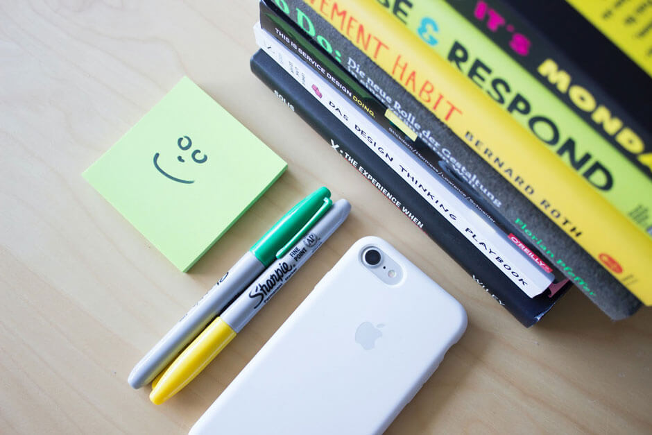 post it pens books and iphone